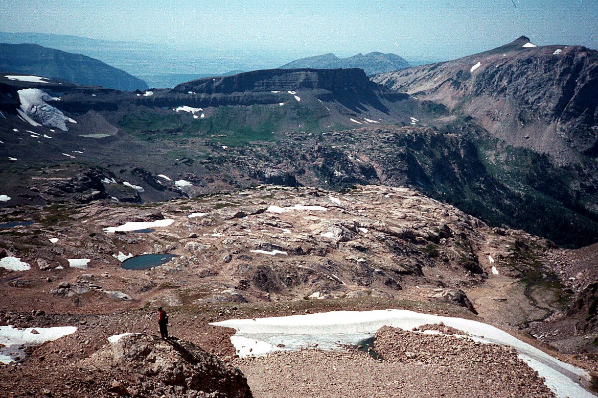 A broad alpine basin and rugged mountain peaks.