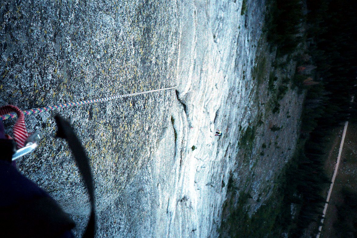 A climber high on a steep rock route.