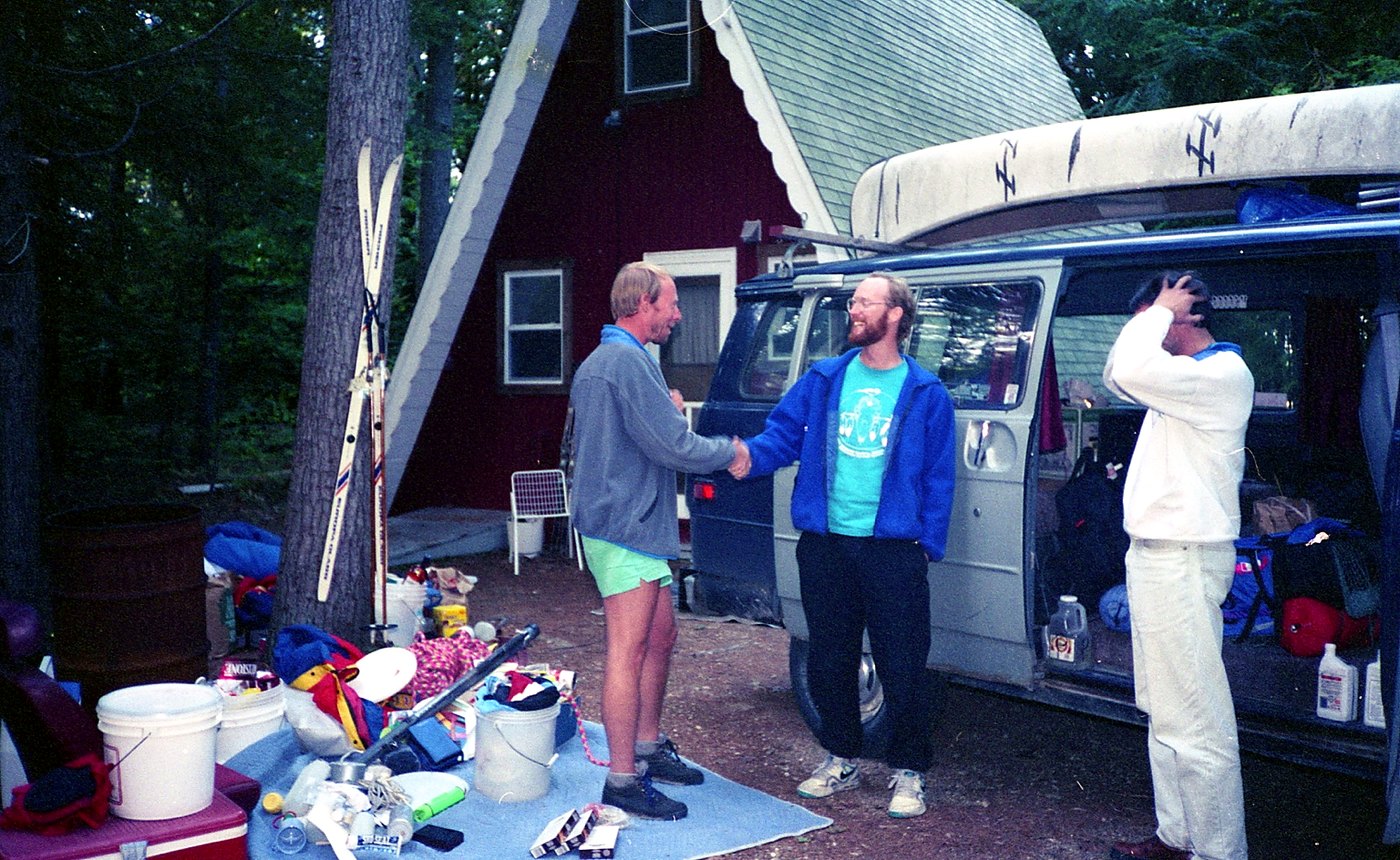 Ricky and Tim shaking hands beside the van after the trip.