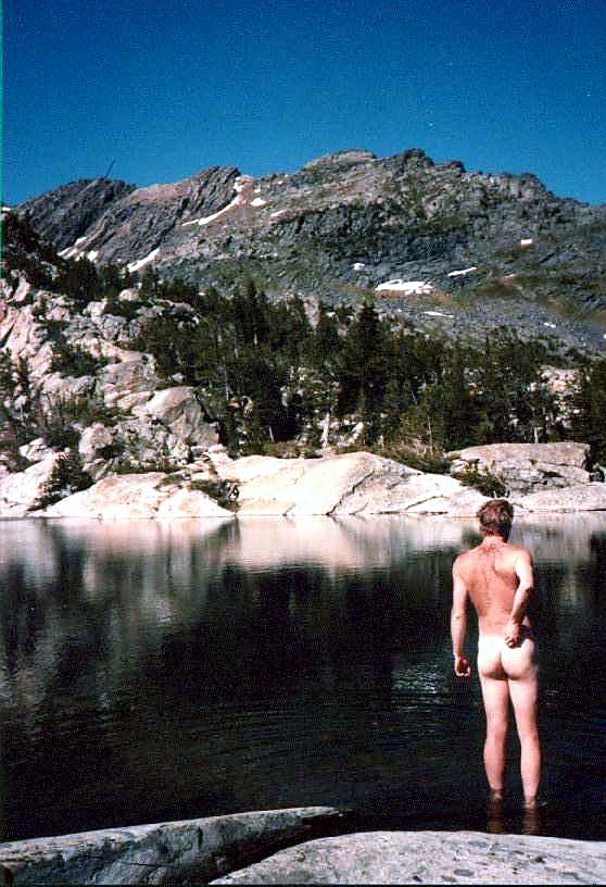A clear alpine lake surrounded by mountains.