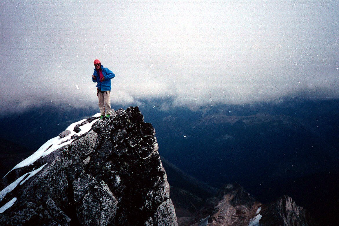 A climber standing on a high mountain ridge during the 1992 trip.