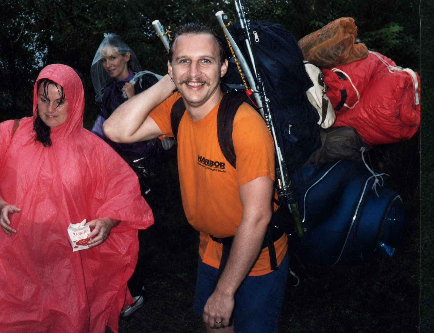 Dann carrying an enormous backpack during a rainy Boston Harbor Islands camping trip