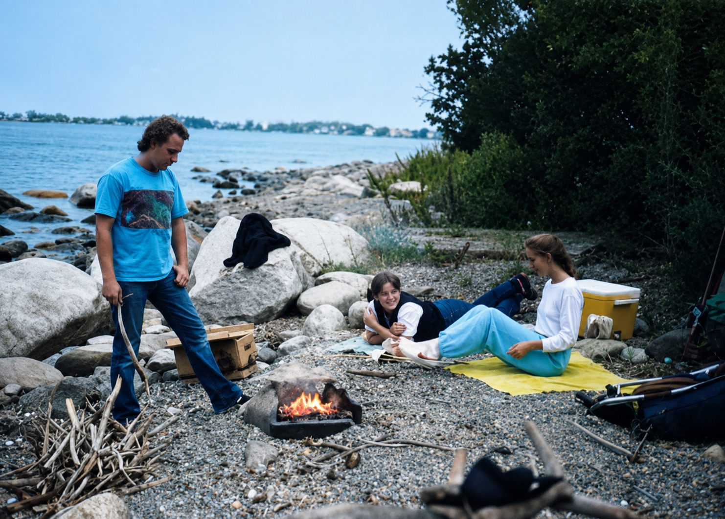 Tim, Diane, and Marty relaxing beside a campfire on a Boston Harbor island