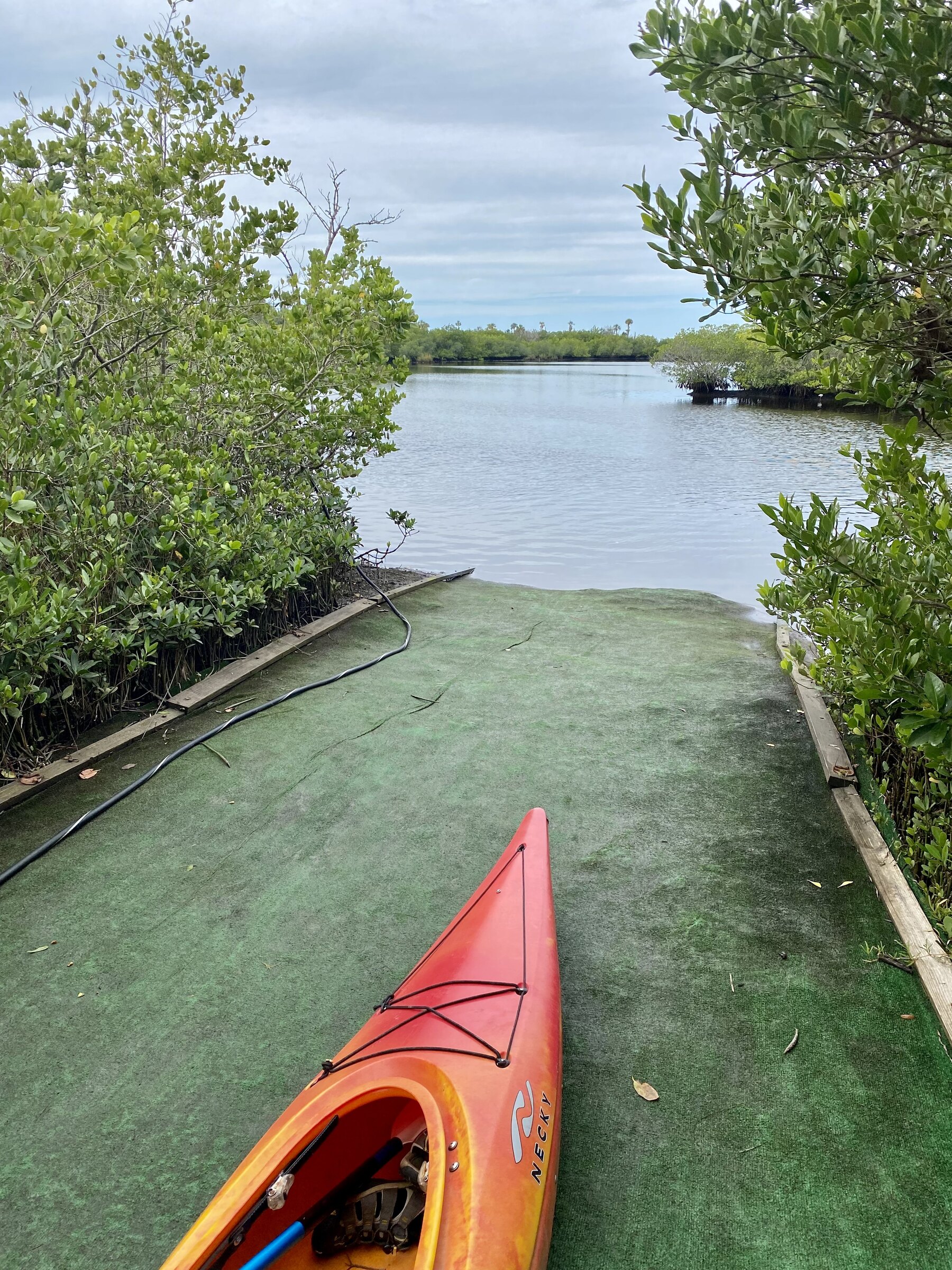 Red kayak entering the launch channel at Werner-Boyce