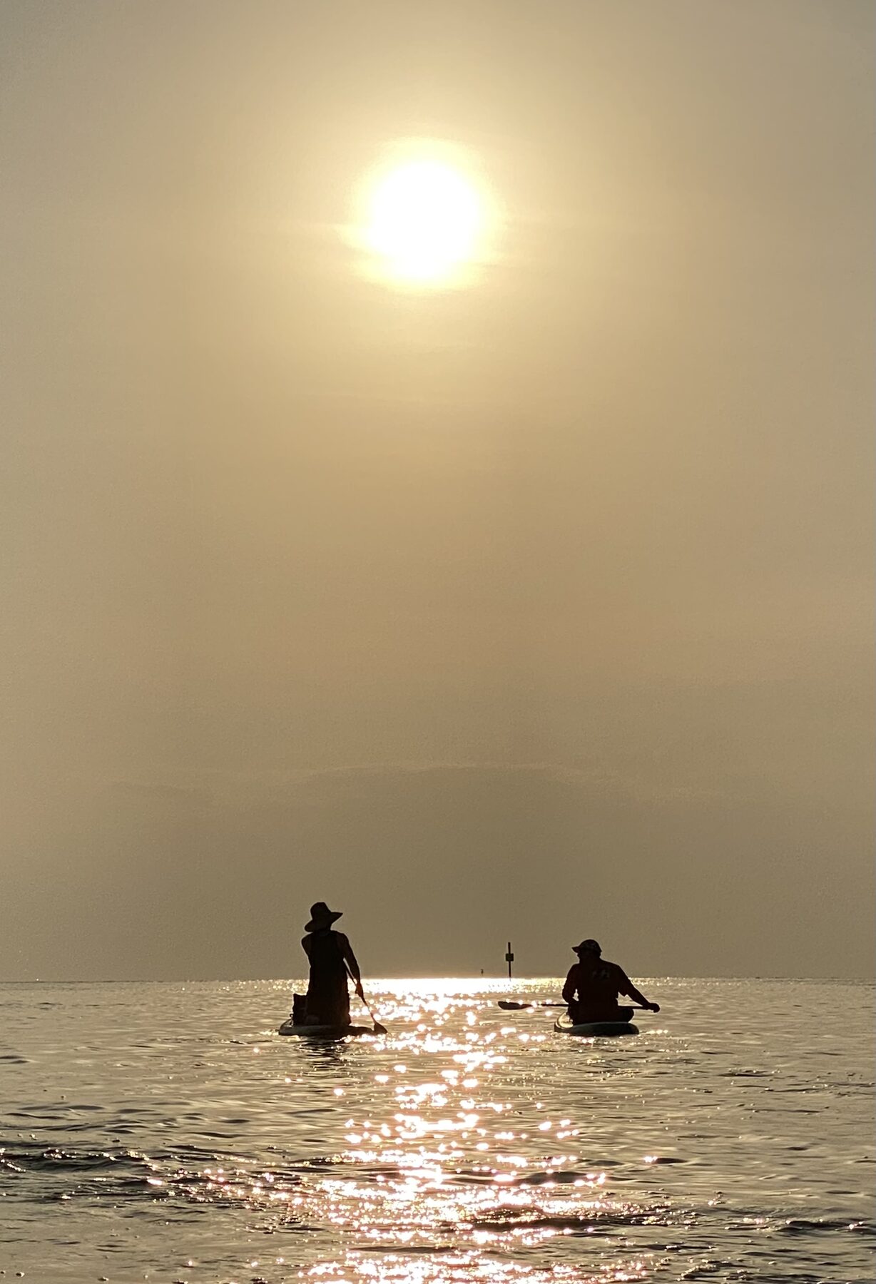 Paddlers beneath sun