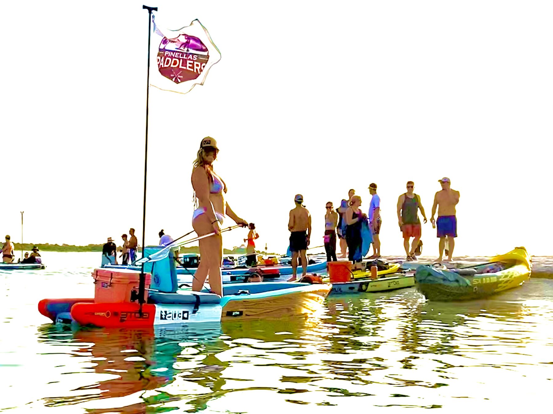 Paddleboards gathering beside the club flag