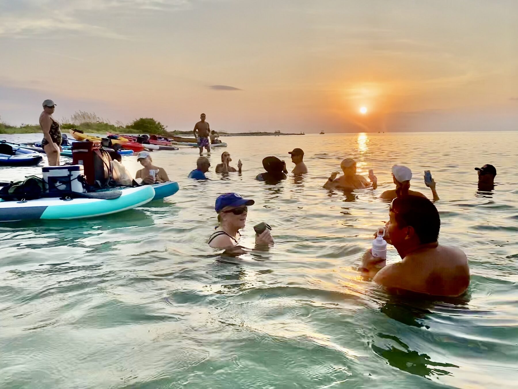 Paddlers swimming and visiting at a sandbar