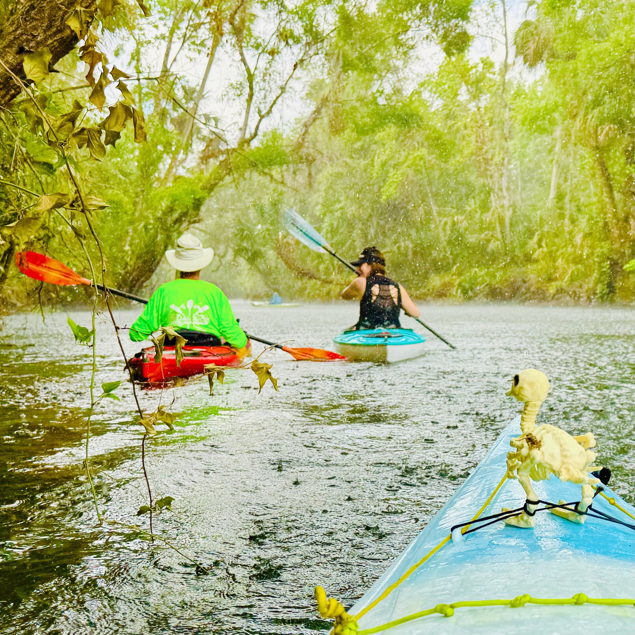 Kayakers paddling through a heavy downpour