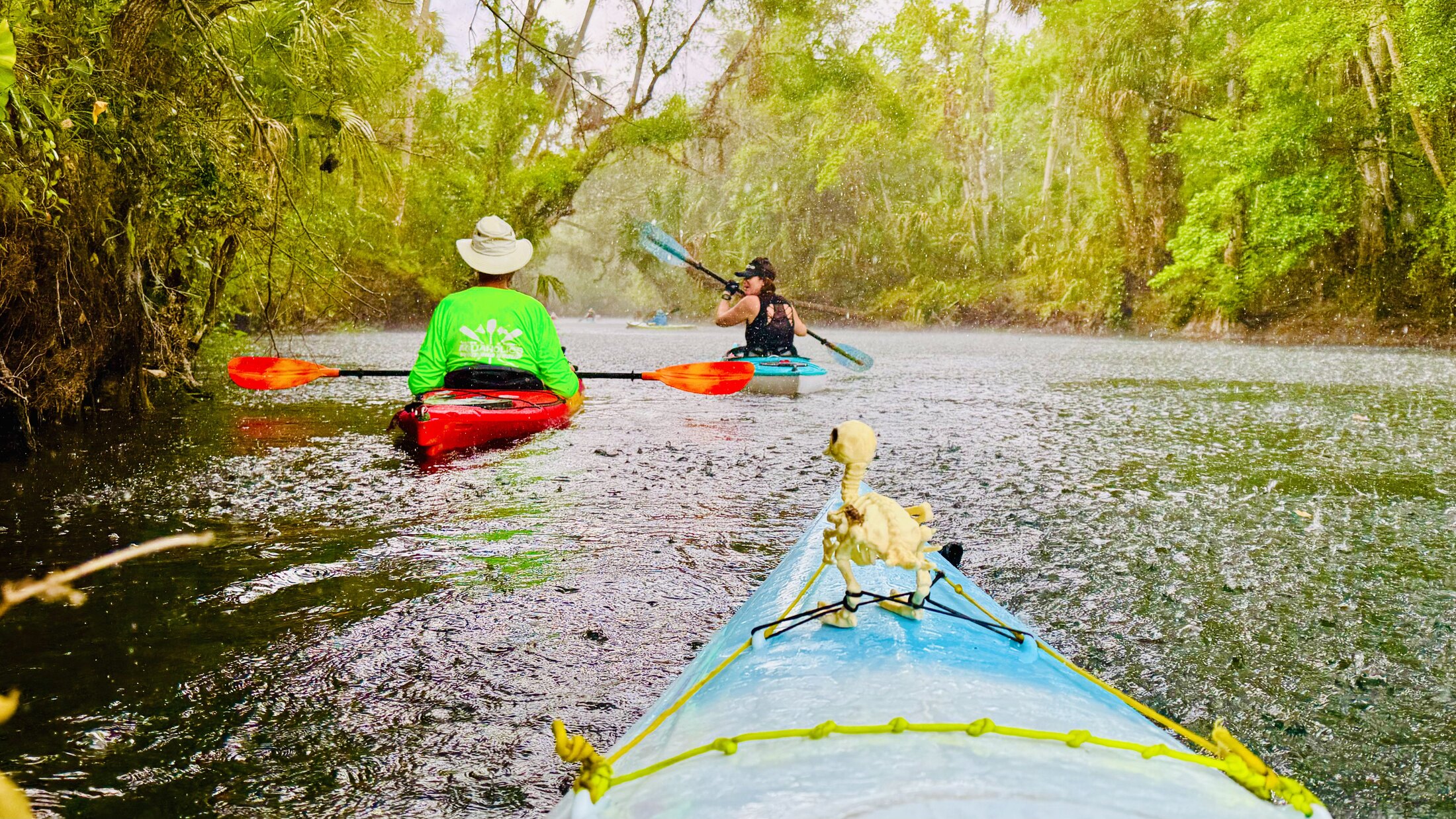 Paddlers following one another through heavy rain