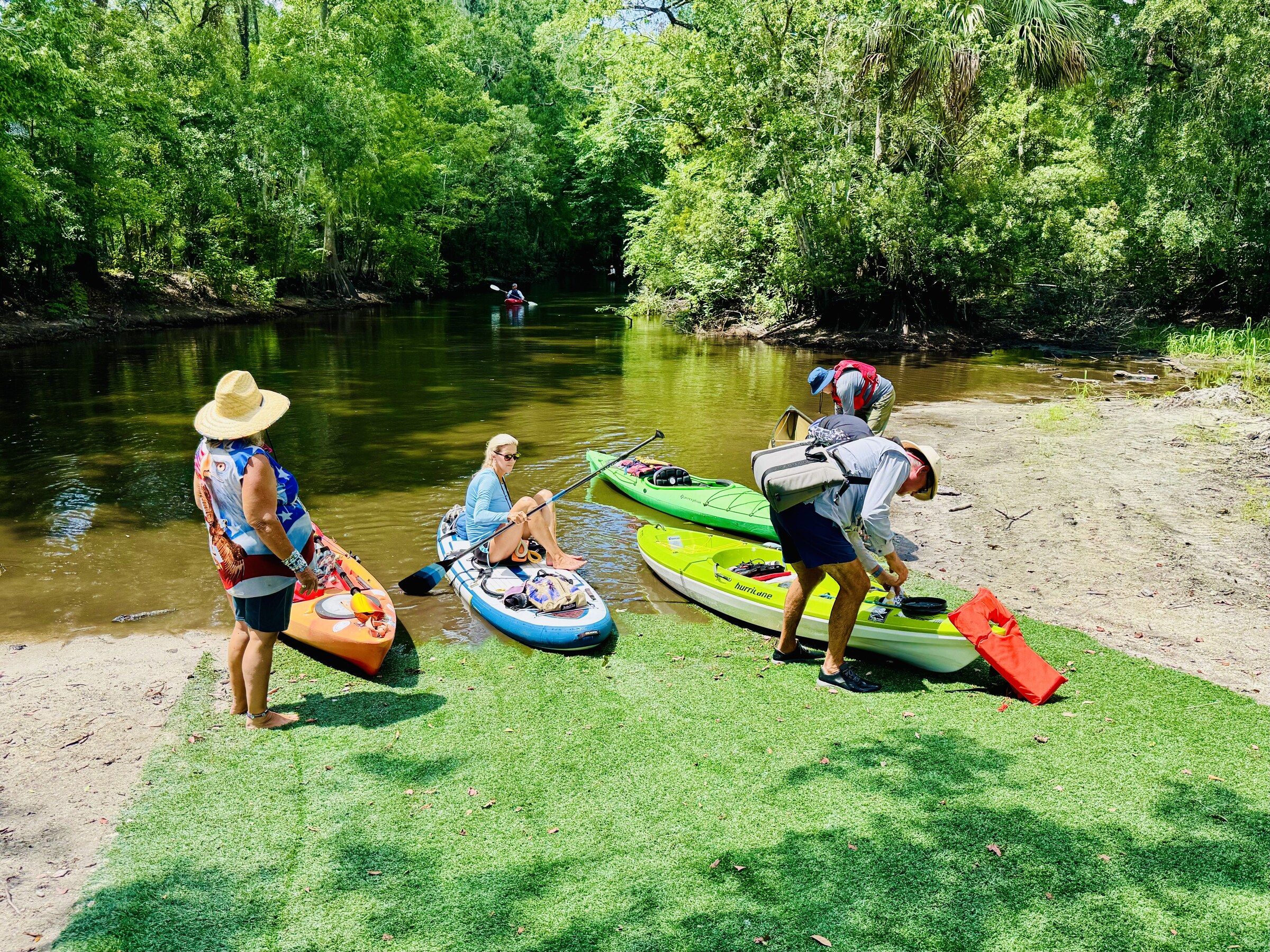 Paddlers carrying kayaks at the takeout after Seventeen Runs