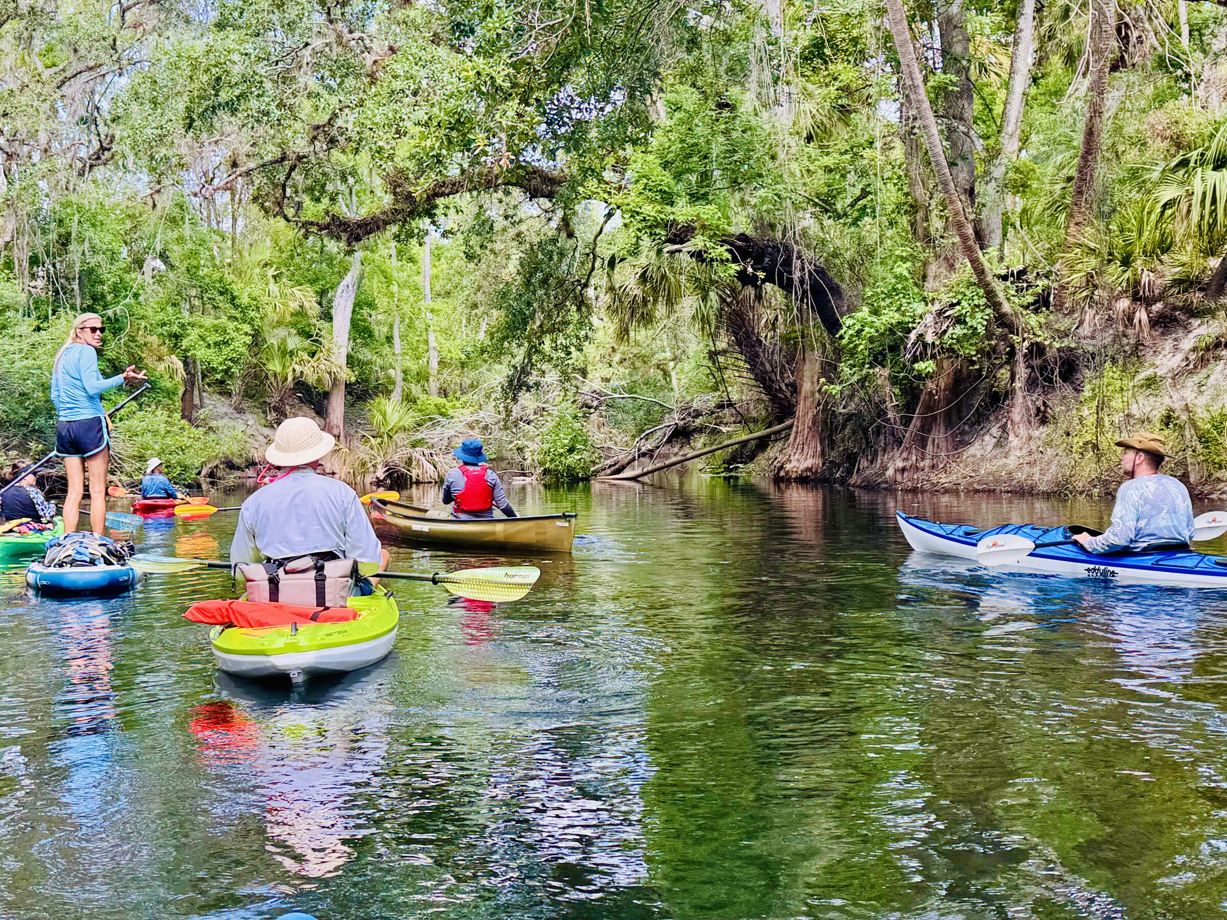 A colorful group of kayaks gathered near the launch