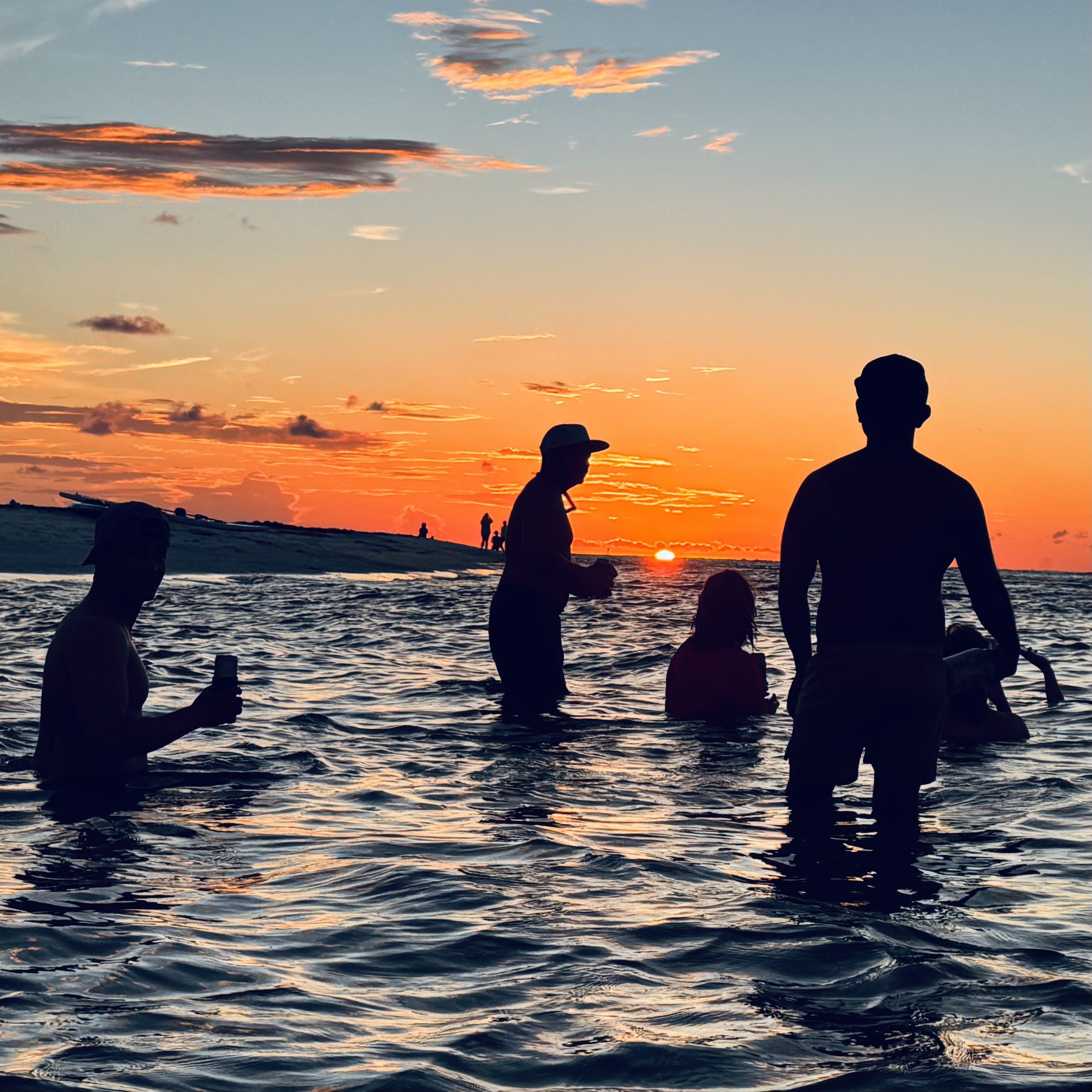 Photo #17: The group lingering in the water as orange light spread across the horizon