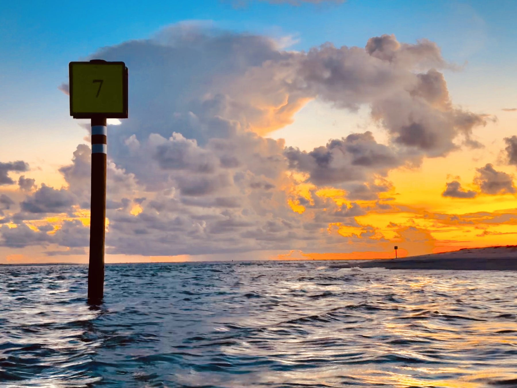 Photo #20: Channel marker 7 framed by storm clouds and the final orange glow