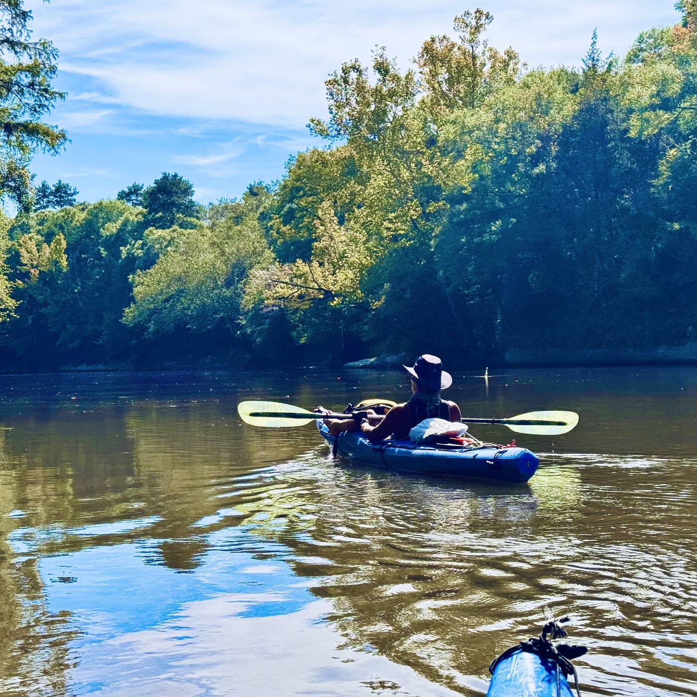 Ray paddling his blue kayak on the Choctawhatchee River