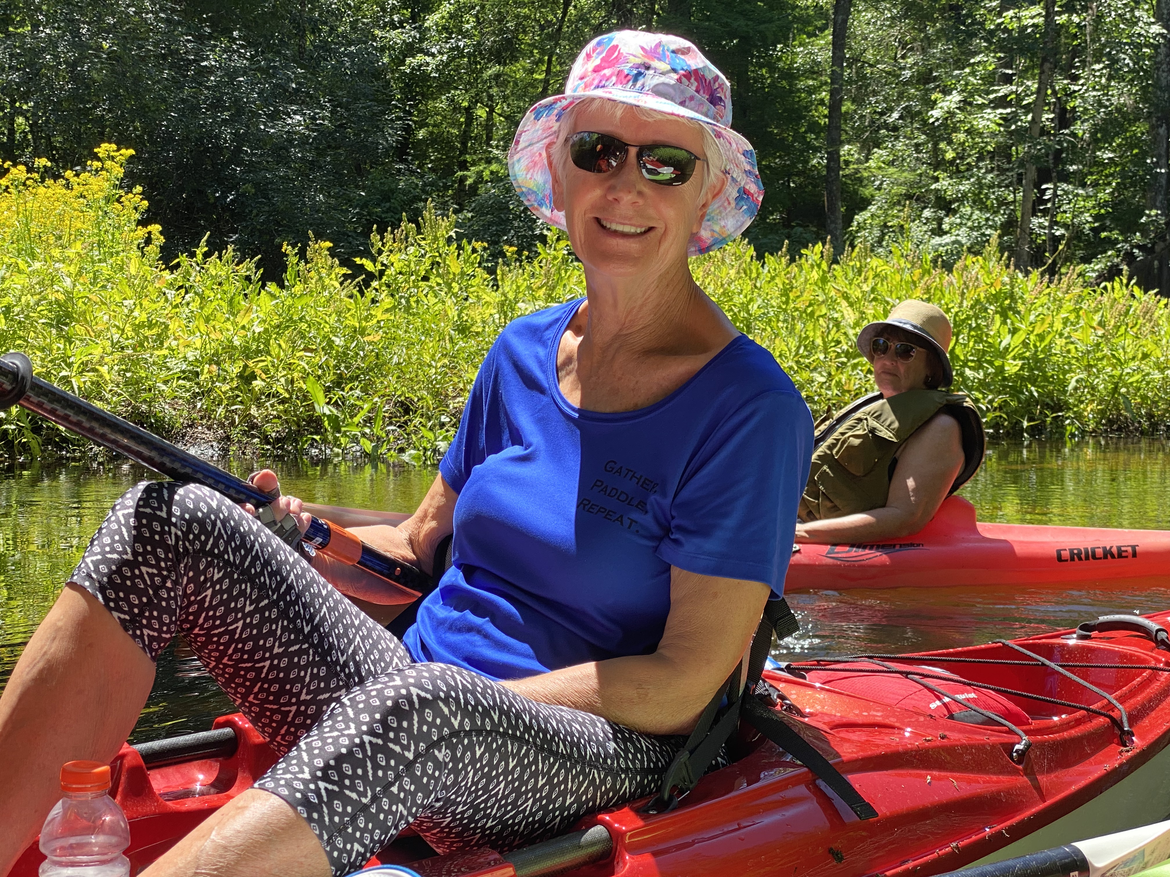 Paddler smiling from a red kayak