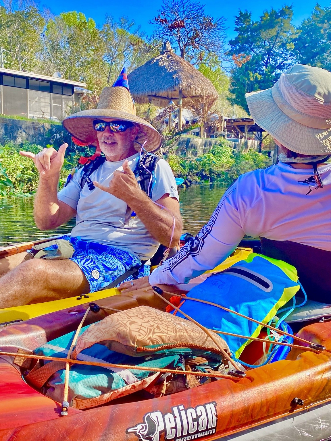 Layne in the birthday hat visiting with another paddler during a quiet pause.