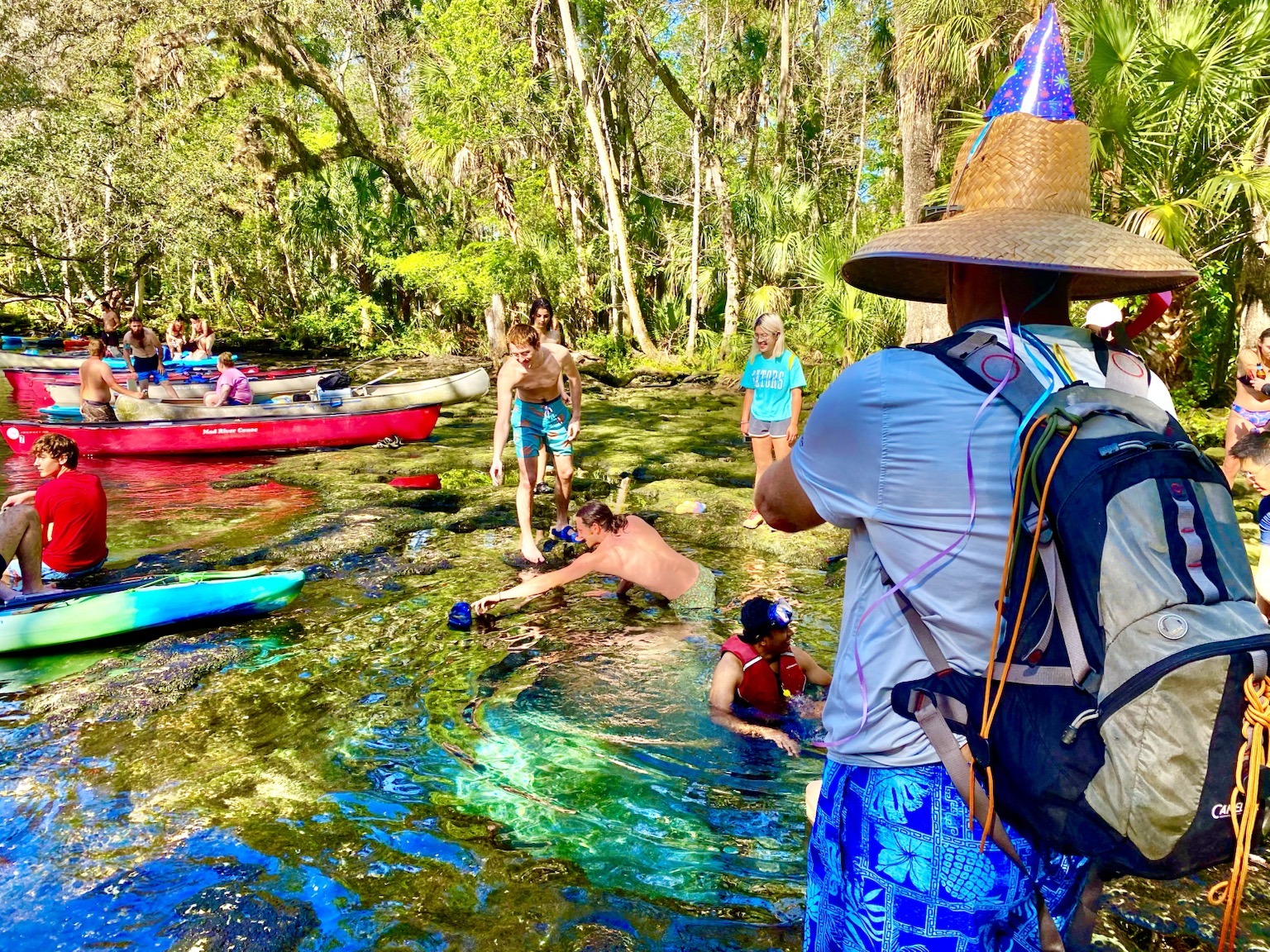 Layne standing at the spring in his oversized birthday hat, surveying the scene.