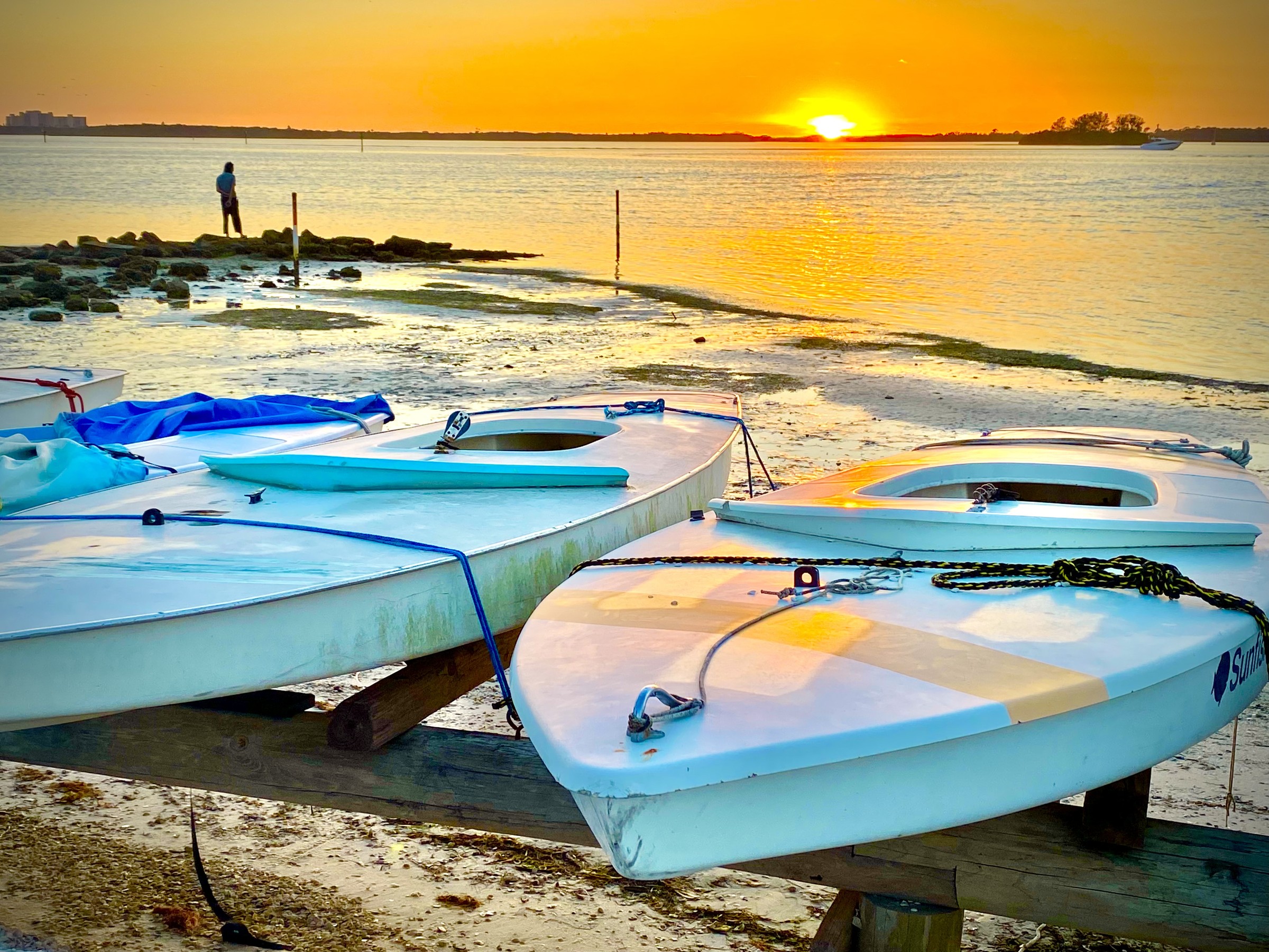 Beached boats glowing in the last light of the day.
