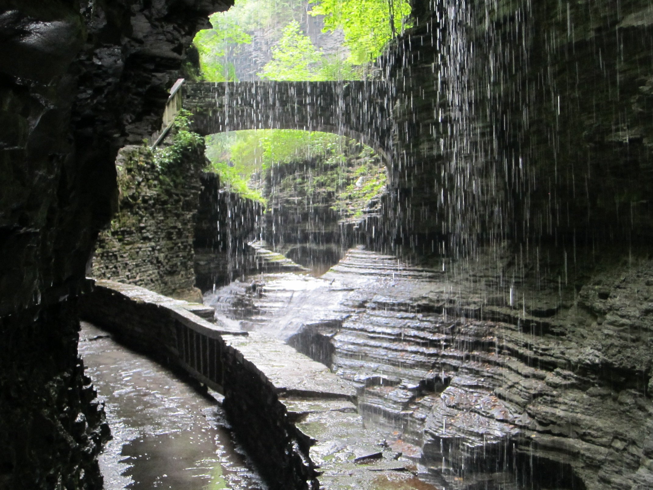 The Gorge Trail passing behind a curtain of falling water.