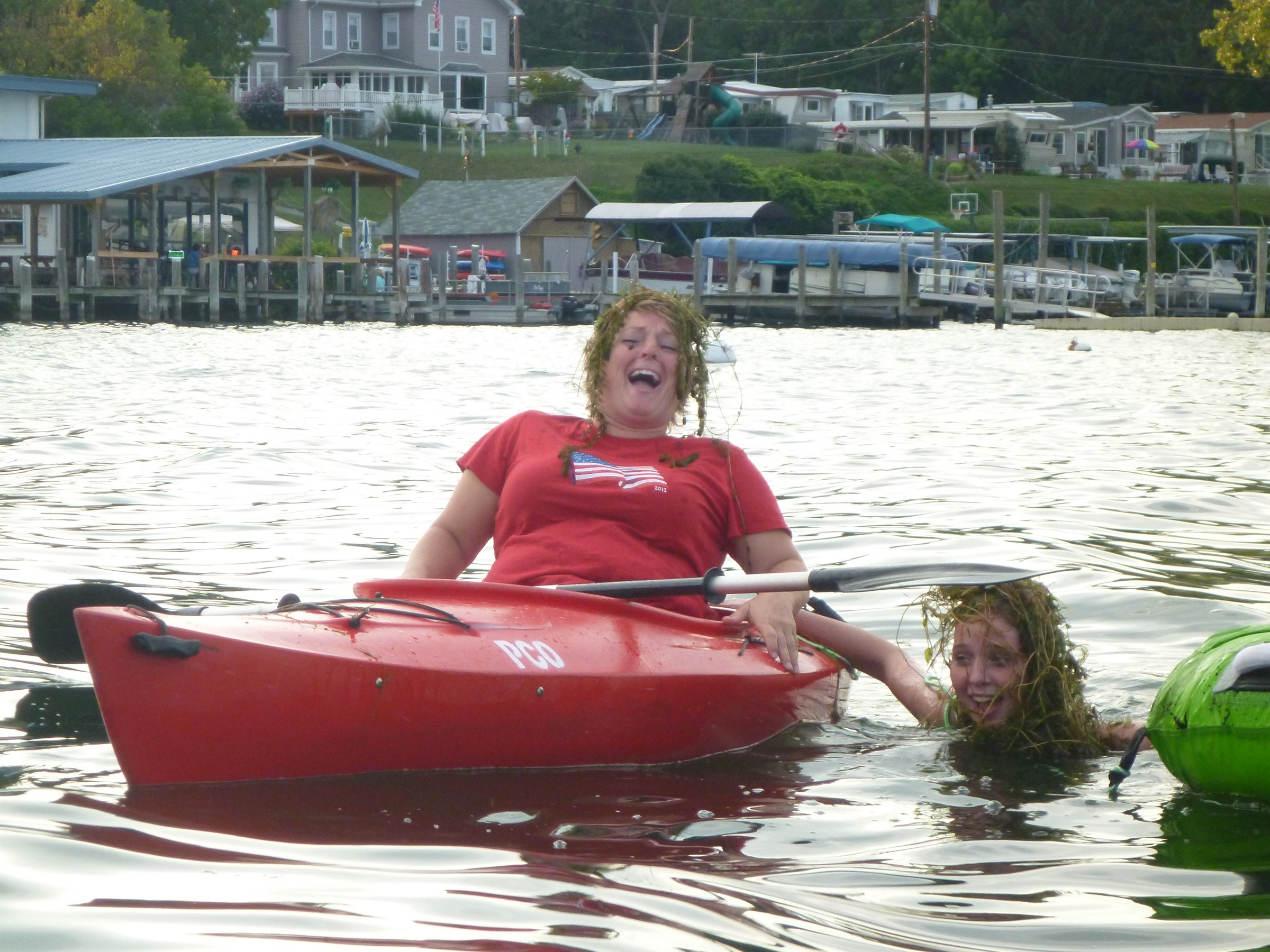 Laughing and splashing beside the kayak.