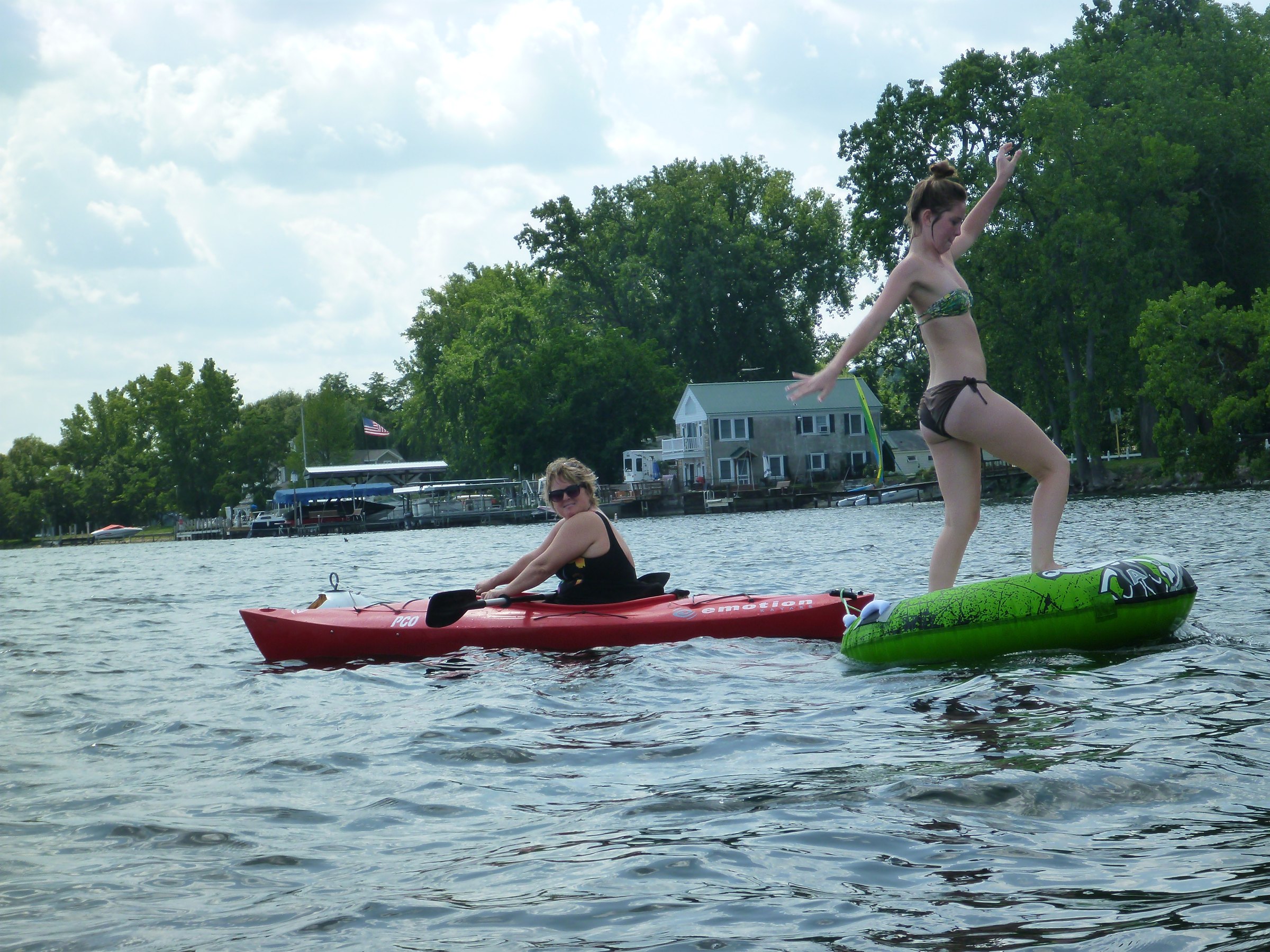 Balancing on the raft while the kayaks circle nearby.
