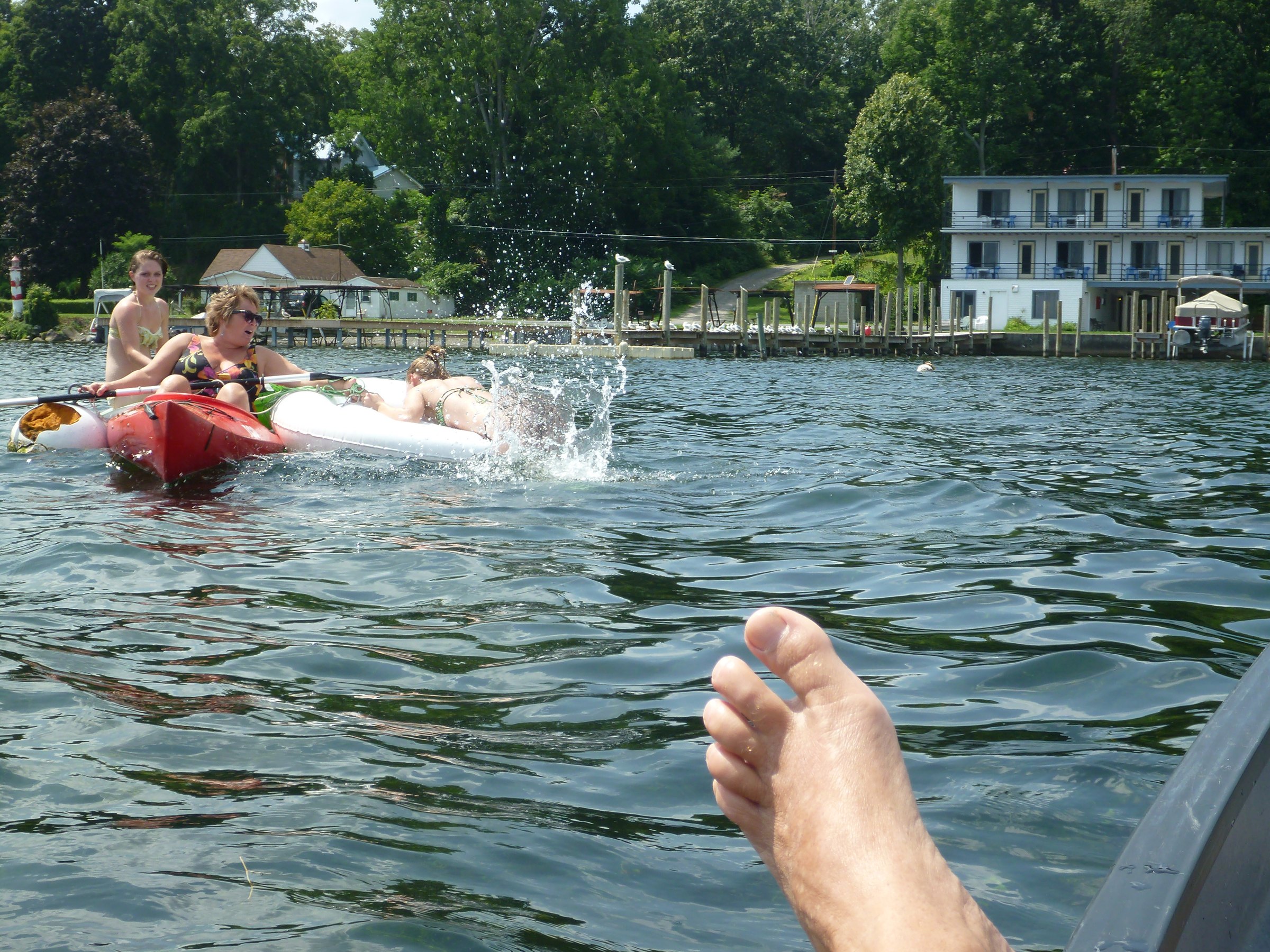 Water splashing between the kayaks and raft.