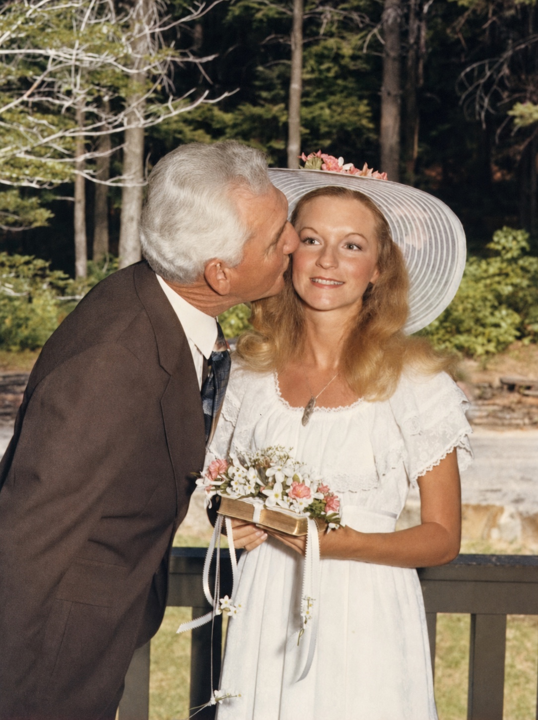 Marty receiving a kiss from her father on her wedding day