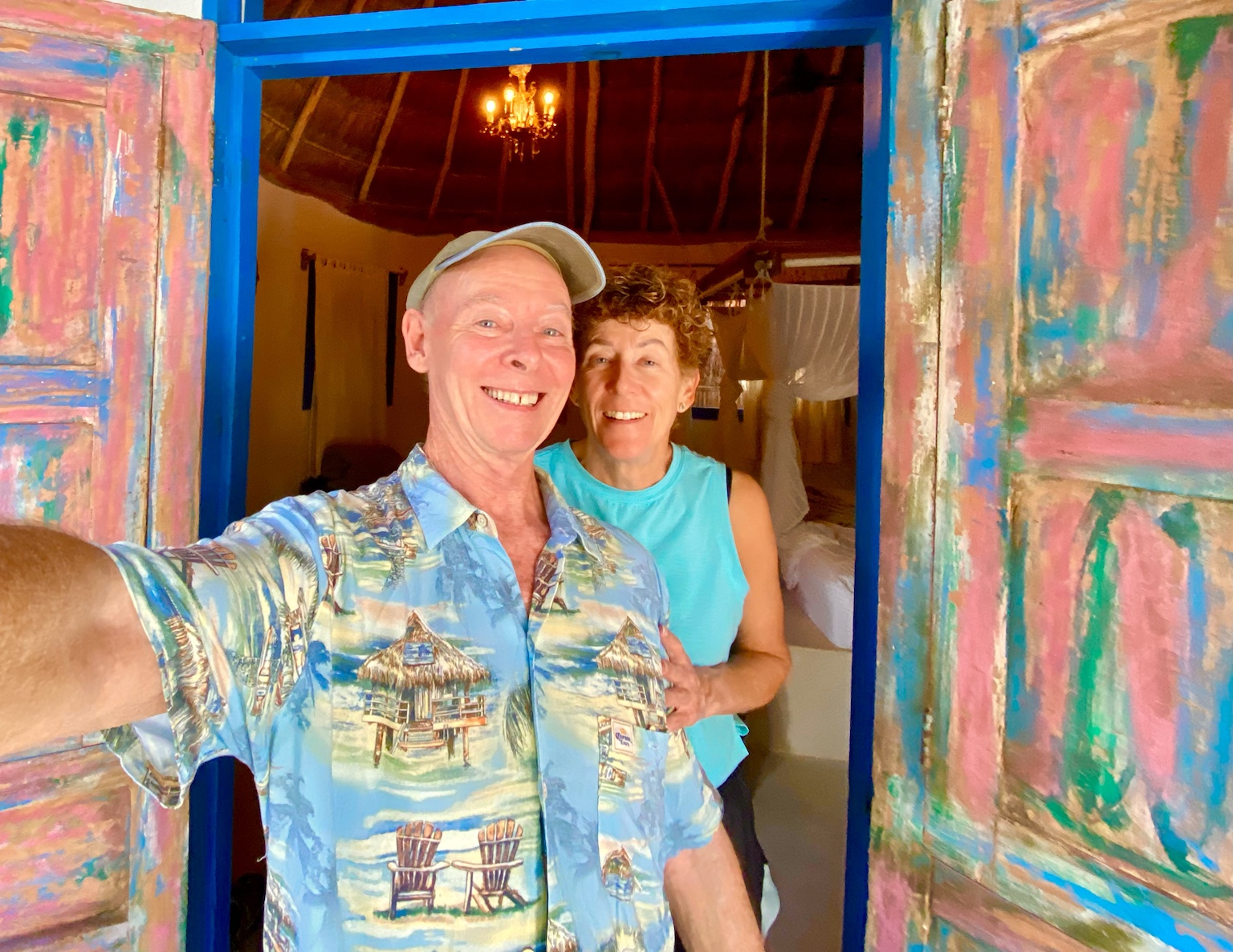 A colorful doorway frames Tim and Kym at their tropical lodging.
