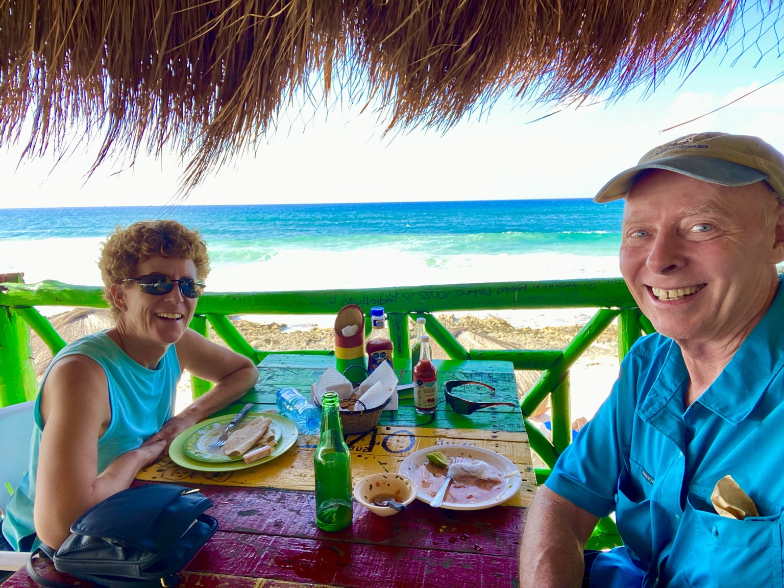 Lunch beneath a palapa with the bright Caribbean Sea filling the background.