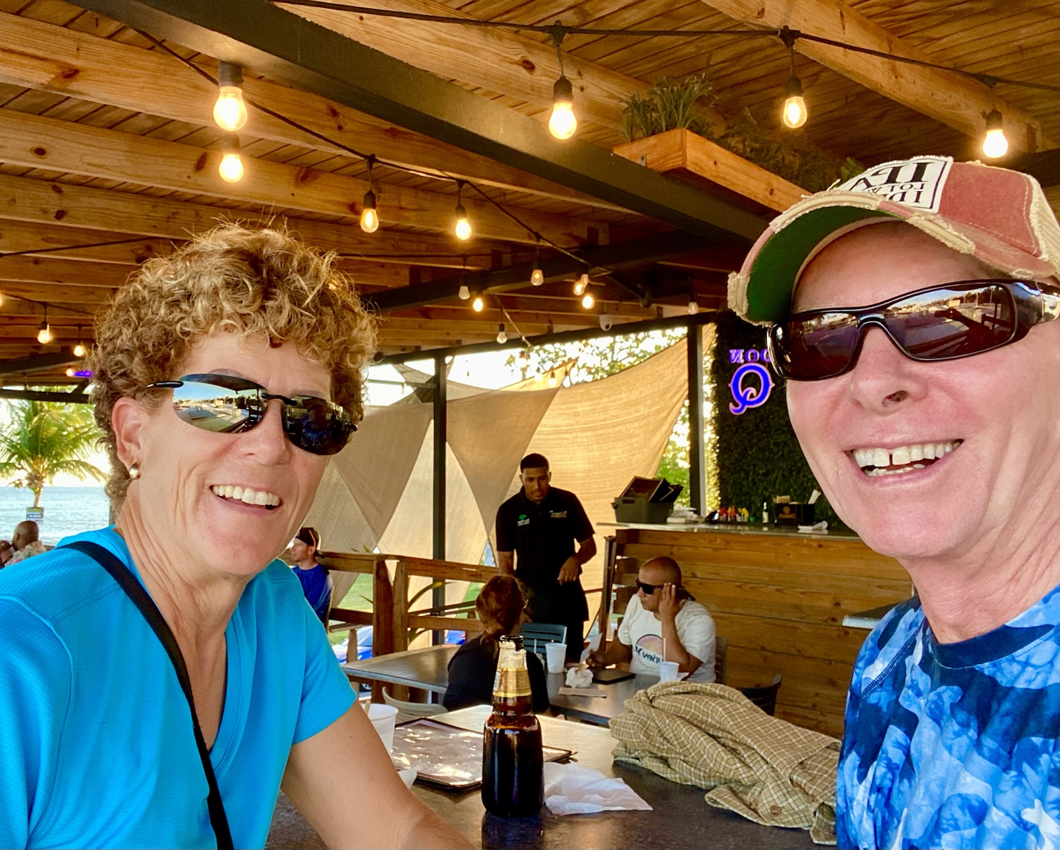 A casual meal at an open-air waterfront restaurant during their tropical travels.