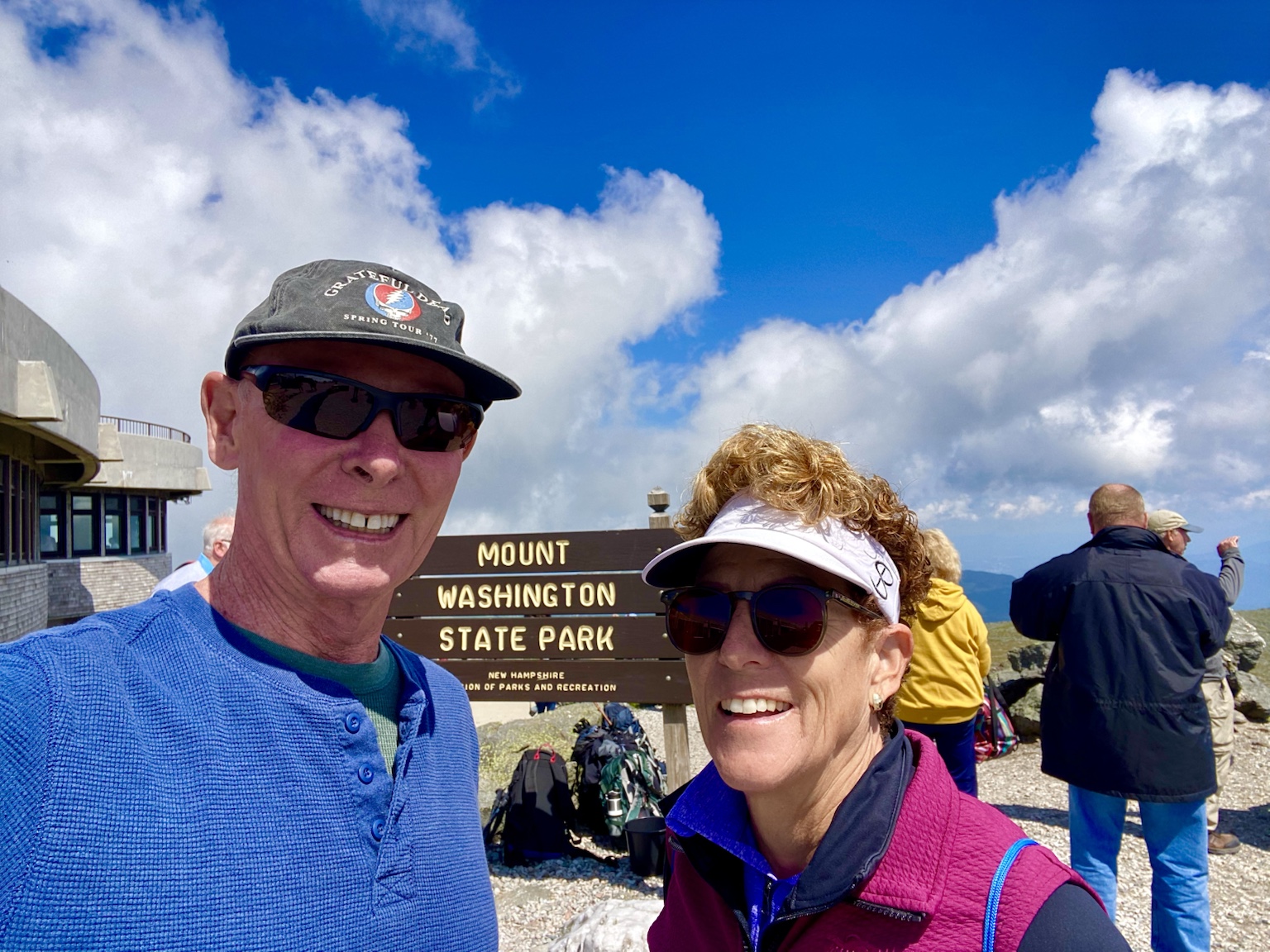 At the summit of Mount Washington beneath a brilliant summer sky.