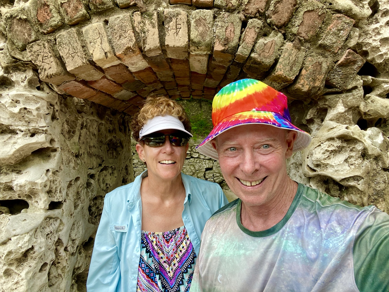 Tim and Kym beneath a rustic stone arch during one of their wanderings.