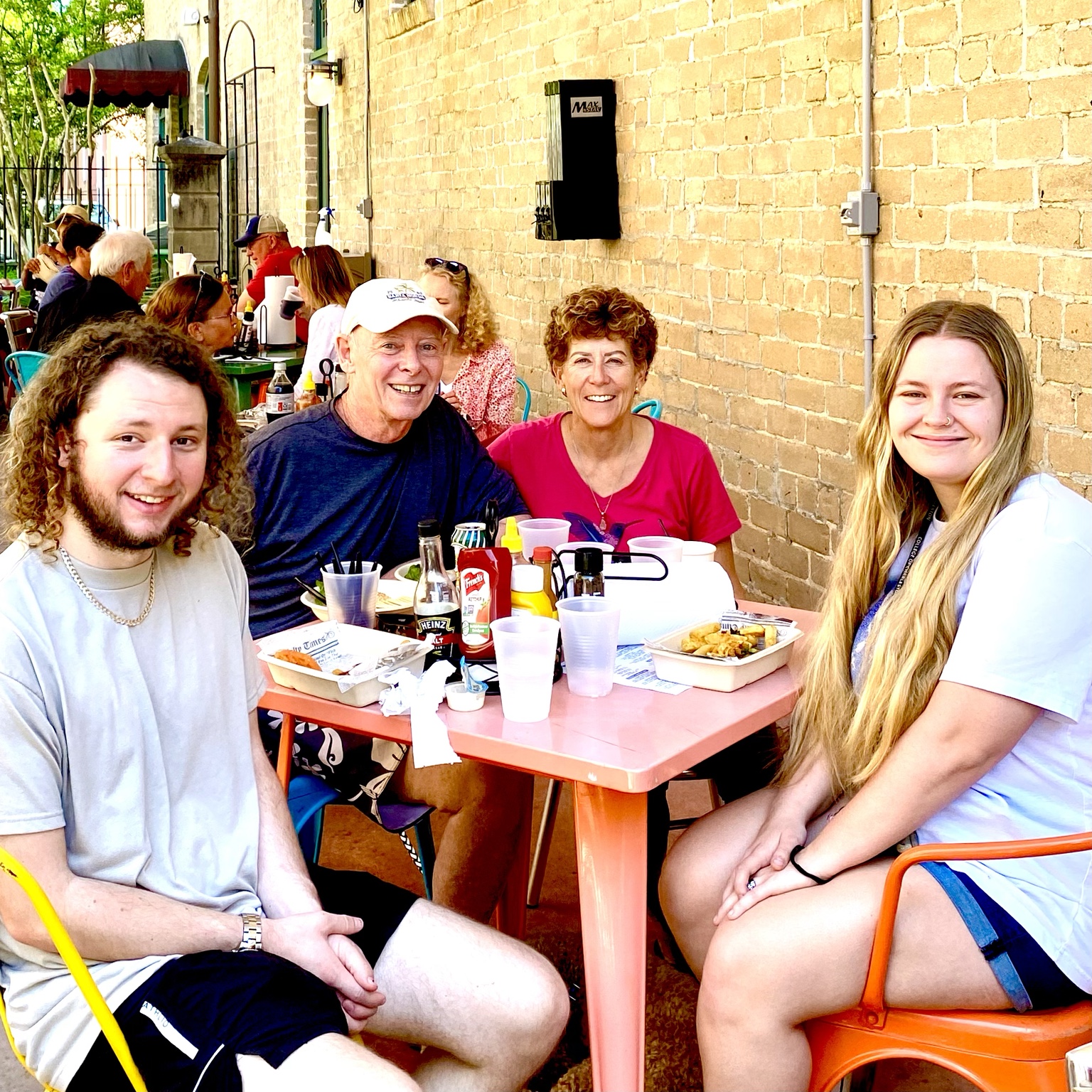 Lunch with younger family members at a sunny outdoor restaurant.