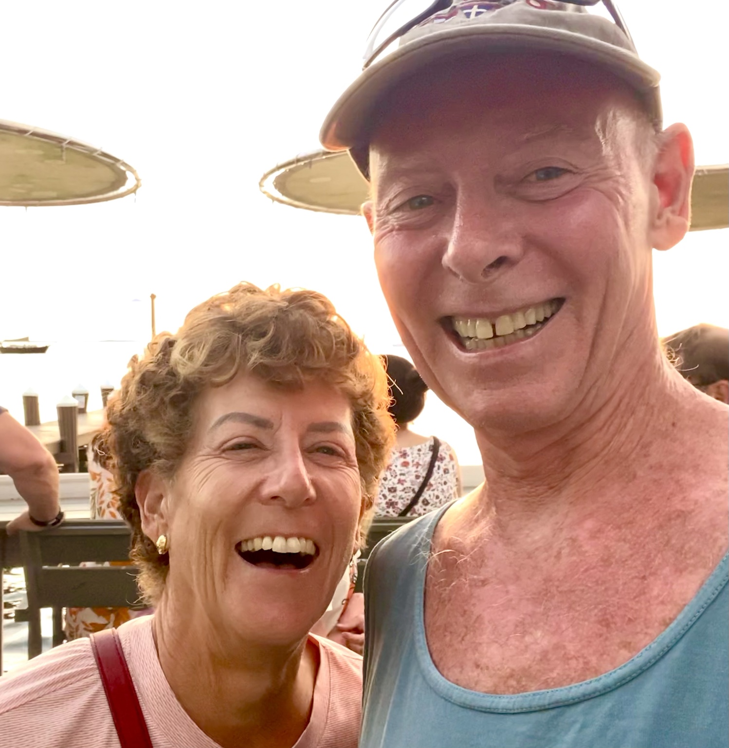 A close, laughing selfie during an evening by the waterfront.