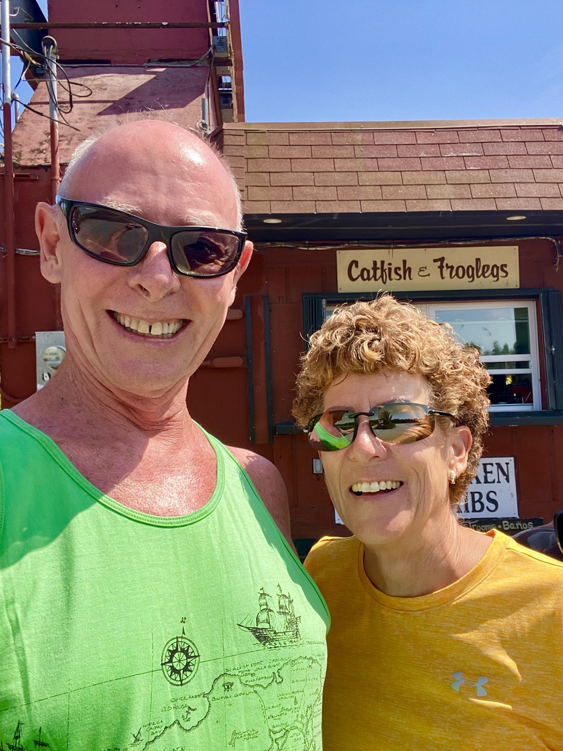 Tim and Kym outside Catfish & Troglegs on a bright sunny day.