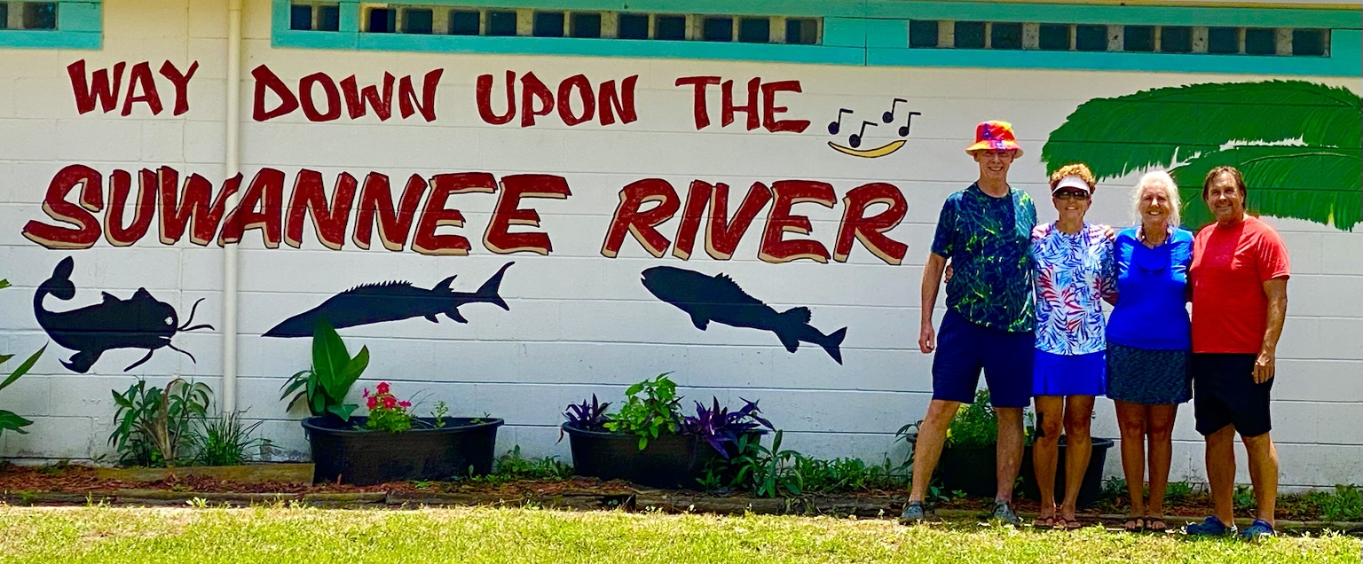 Friends together beneath the “Way Down Upon the Suwannee River” mural.