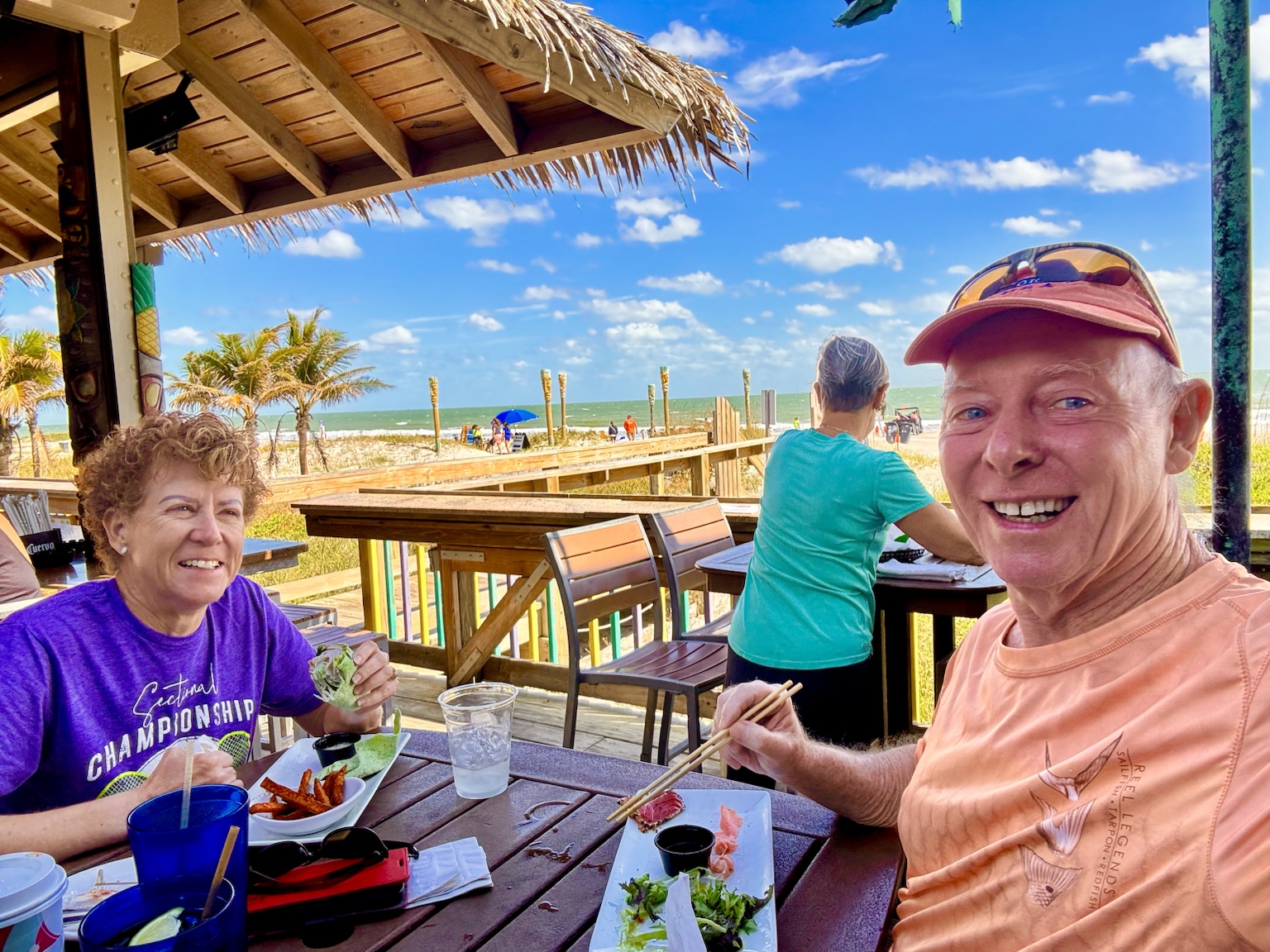 Lunch at a beachside restaurant with the Gulf and blue sky beyond the deck.